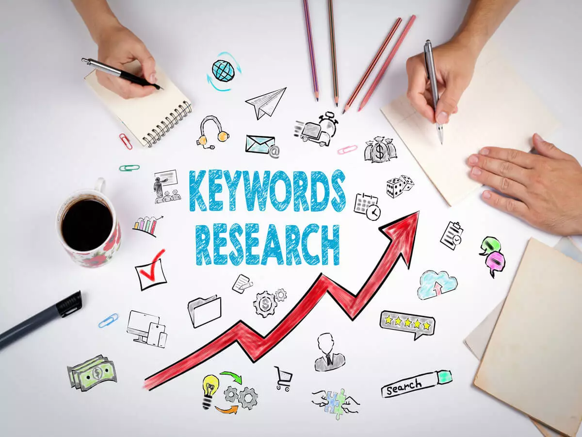 Keyword Research Infographic showing hands trying to pick up letters